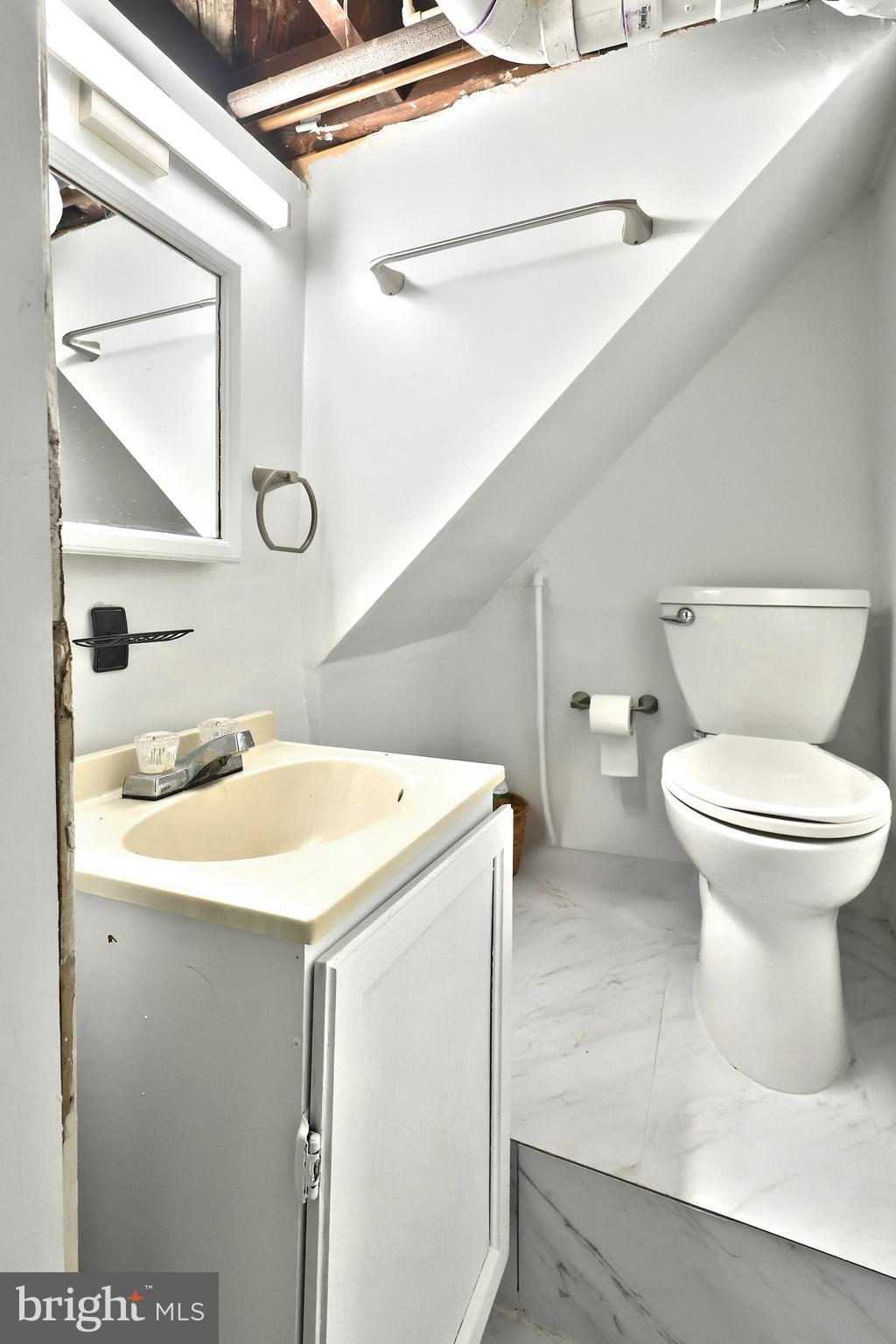 615 Dunkirk Road Baltimore, MD 21212 - Photo 38 of 45 a bathroom with a sink a toilet and a mirror