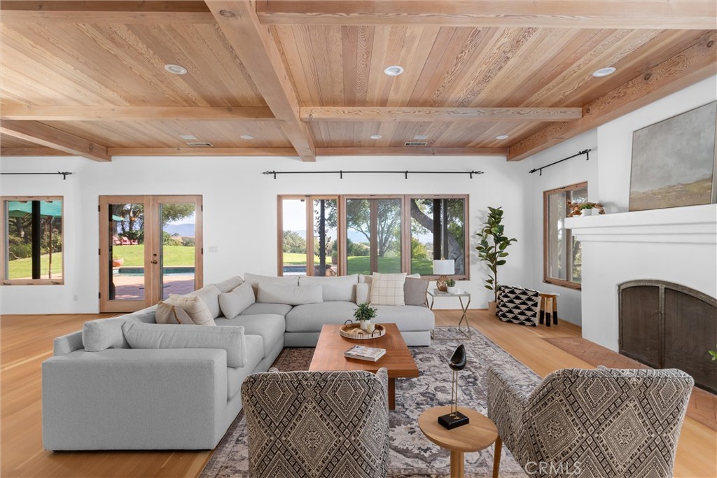 3595 West Oak Trail Road Santa Ynez, CA 93460 - Photo 13 of 60 a living room with furniture a fireplace and a dining table