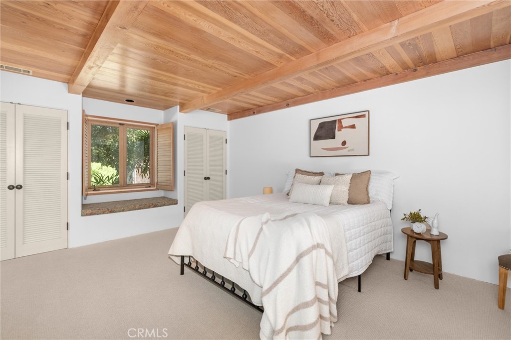 3595 West Oak Trail Road Santa Ynez, CA 93460 - Photo 24 of 60 a spacious bedroom with a bed and a window