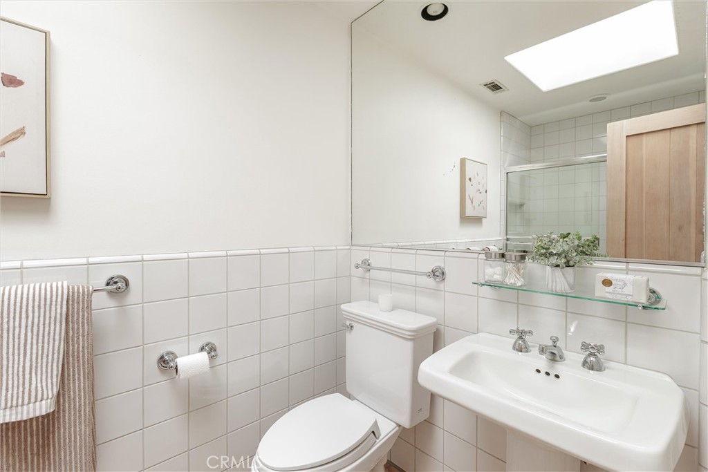 3595 West Oak Trail Road Santa Ynez, CA 93460 - Photo 26 of 60 a bathroom with a sink a toilet and mirror