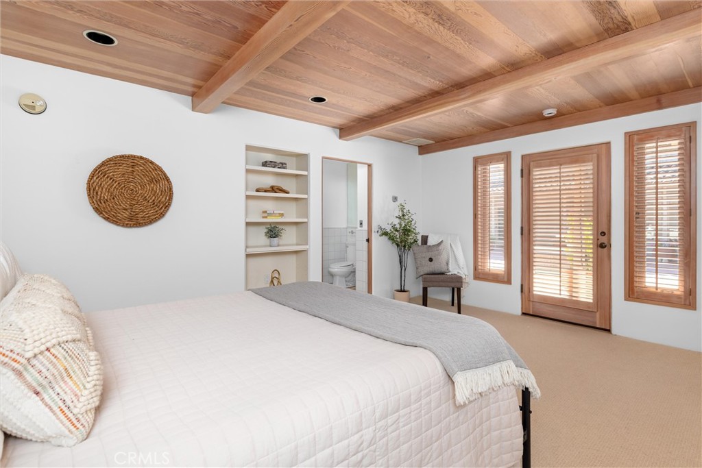3595 West Oak Trail Road Santa Ynez, CA 93460 - Photo 28 of 60 a bedroom with a large bed and a chandelier
