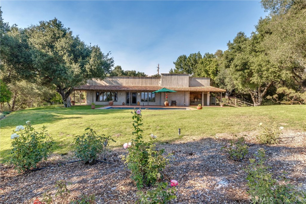 3595 West Oak Trail Road Santa Ynez, CA 93460 - Photo 45 of 60 a view of a house with garden and trees in the background