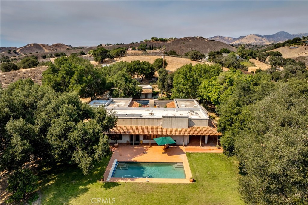 3595 West Oak Trail Road Santa Ynez, CA 93460 - Photo 51 of 60 a view of a big yard with swimming pool and mountains