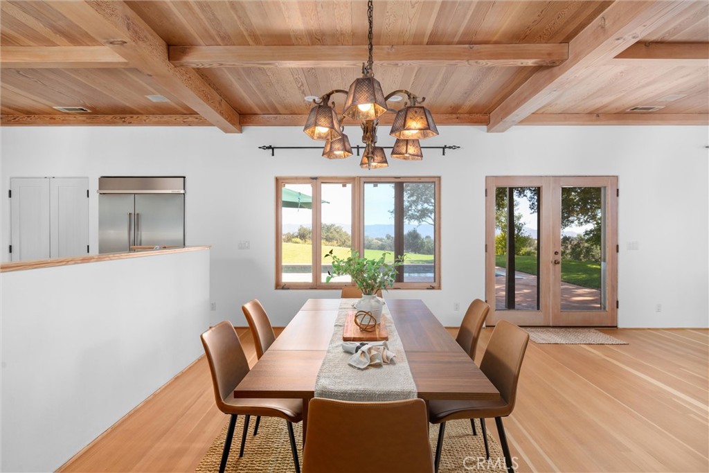3595 West Oak Trail Road Santa Ynez, CA 93460 - Photo 10 of 60 a view of a dining room with furniture wooden floor and chandelier