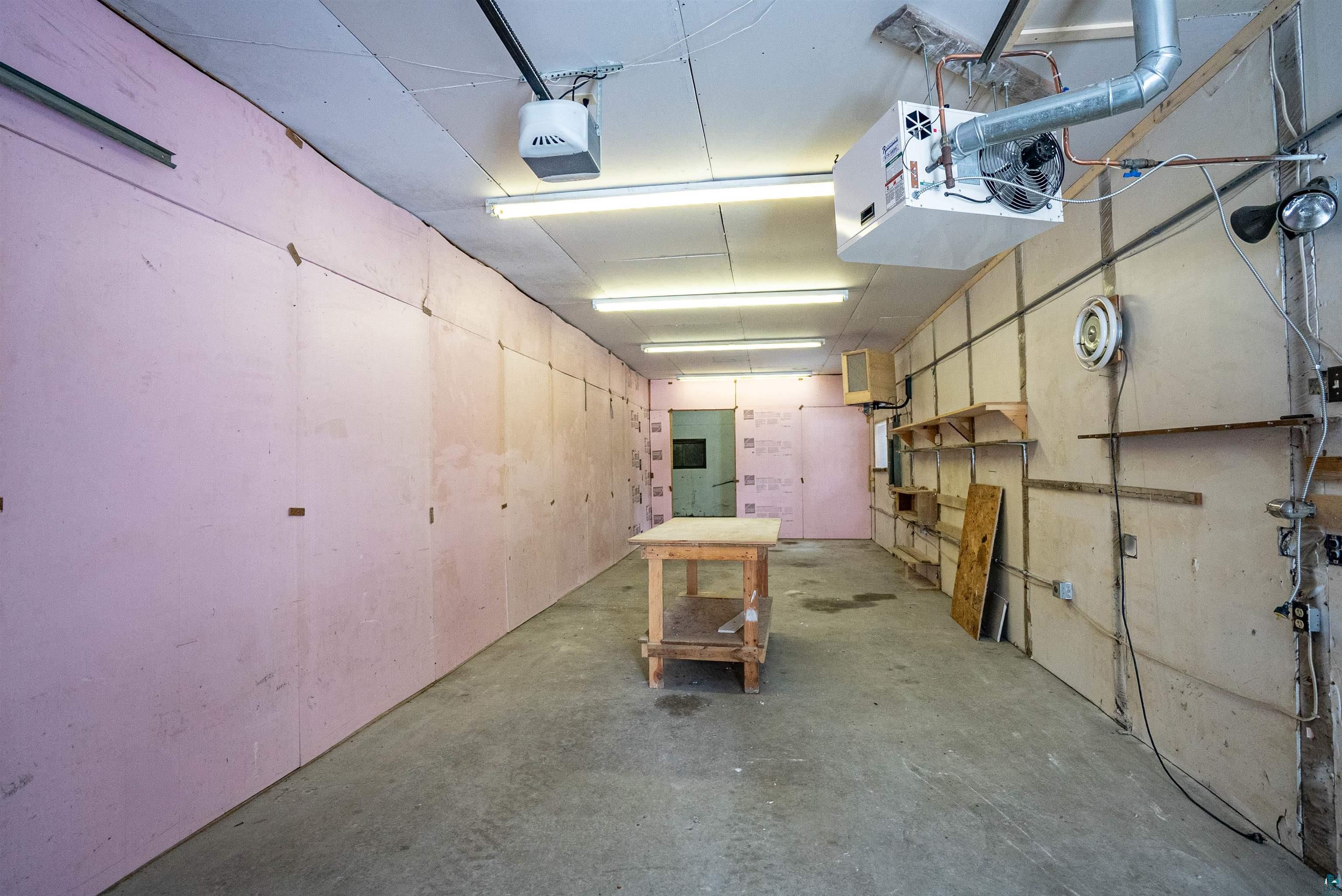 1580 Olsonville Road Carlton, MN 55718 - Photo 18 of 30 Garage with a heating unit and a garage door opener