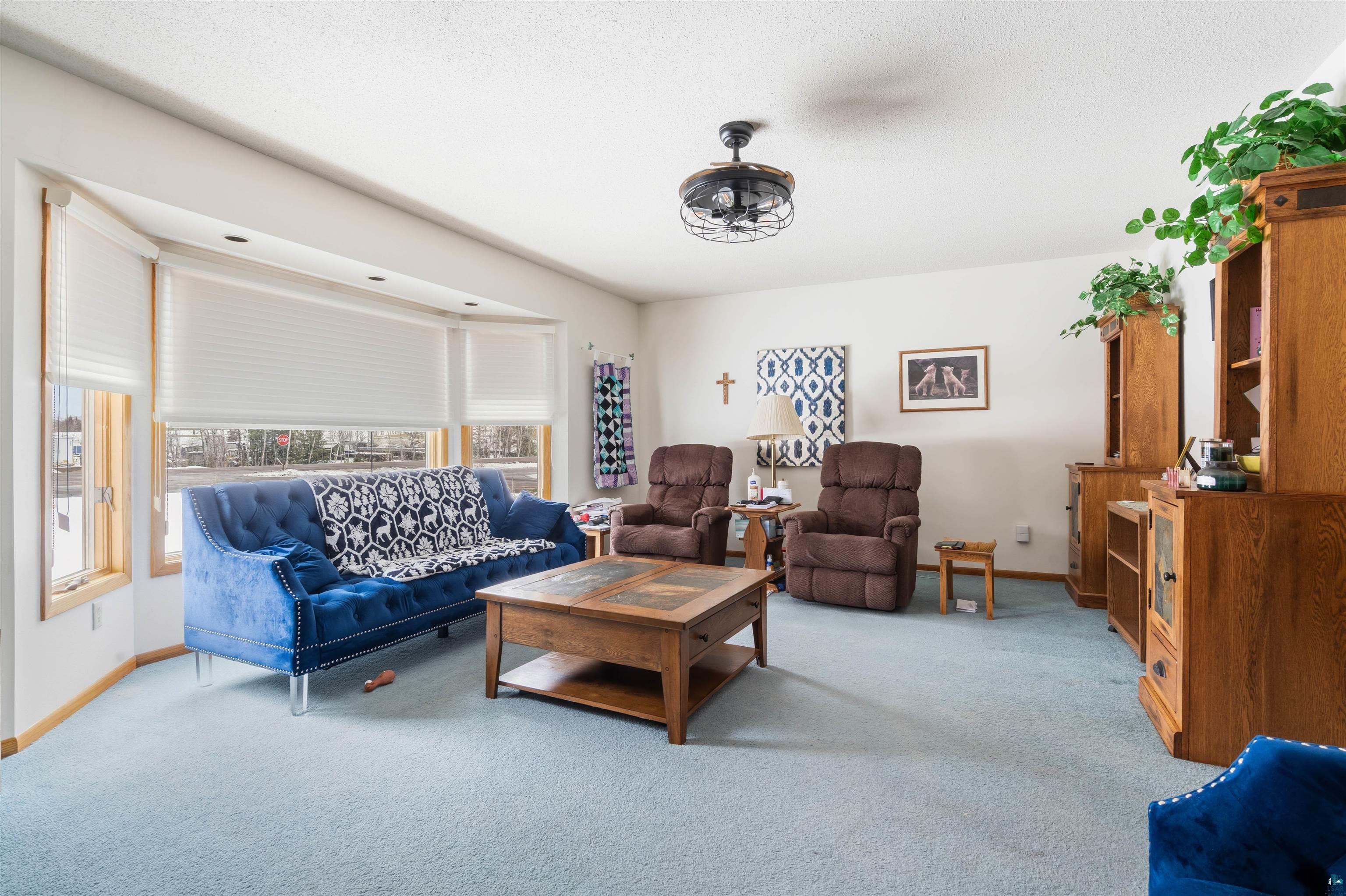 1580 Olsonville Road Carlton, MN 55718 - Photo 4 of 30 Living area featuring light colored carpet and ceiling fan