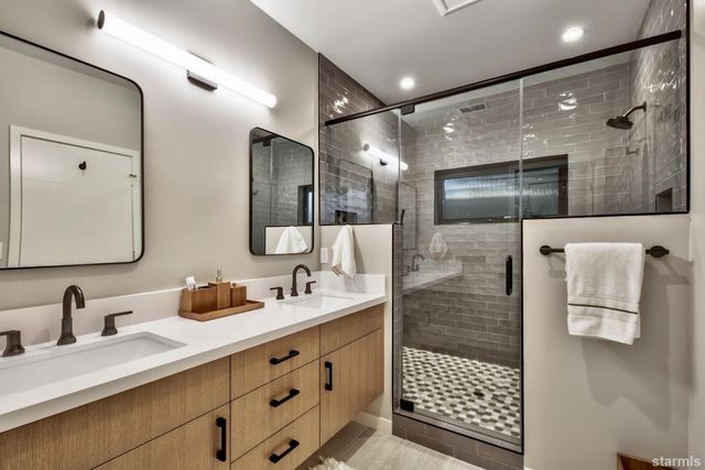 a bathroom with a shower sink and mirror