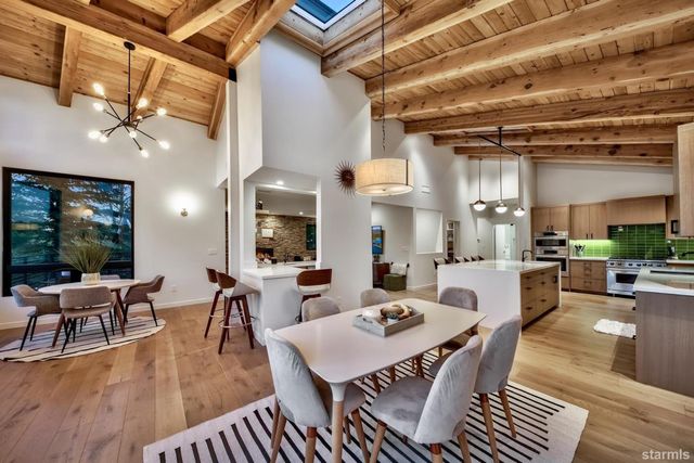 a living room with lots of furniture and view of kitchen