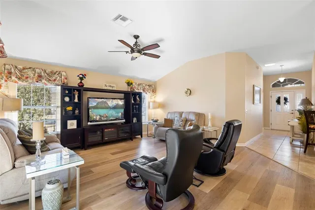a bedroom with a bed and a flat tv screen on dresser