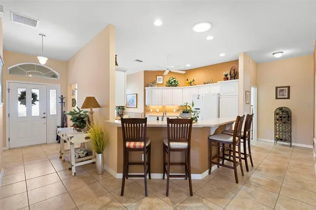 a kitchen with cabinets appliances and a window
