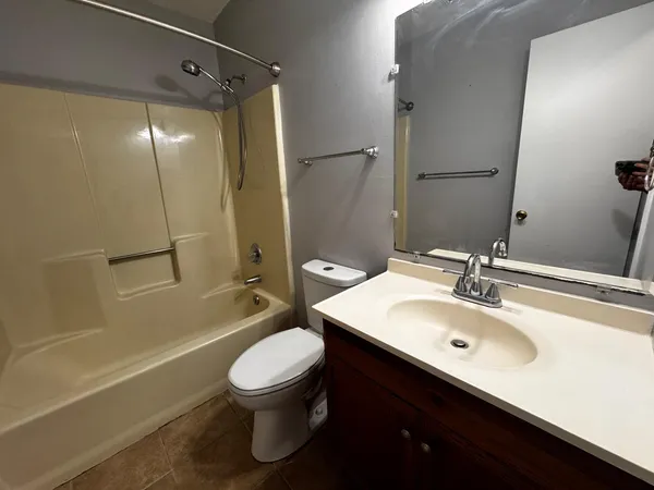 a bathroom with a sink toilet tub and shower
