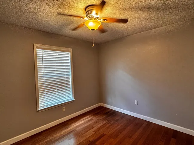 a view of room with window and ceiling fan