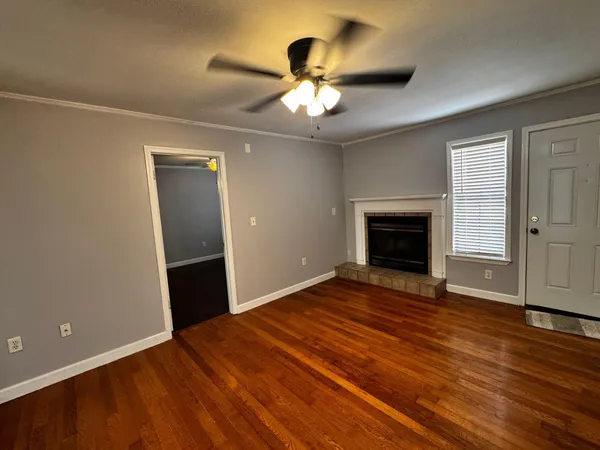 wooden floor in an empty room with a fireplace