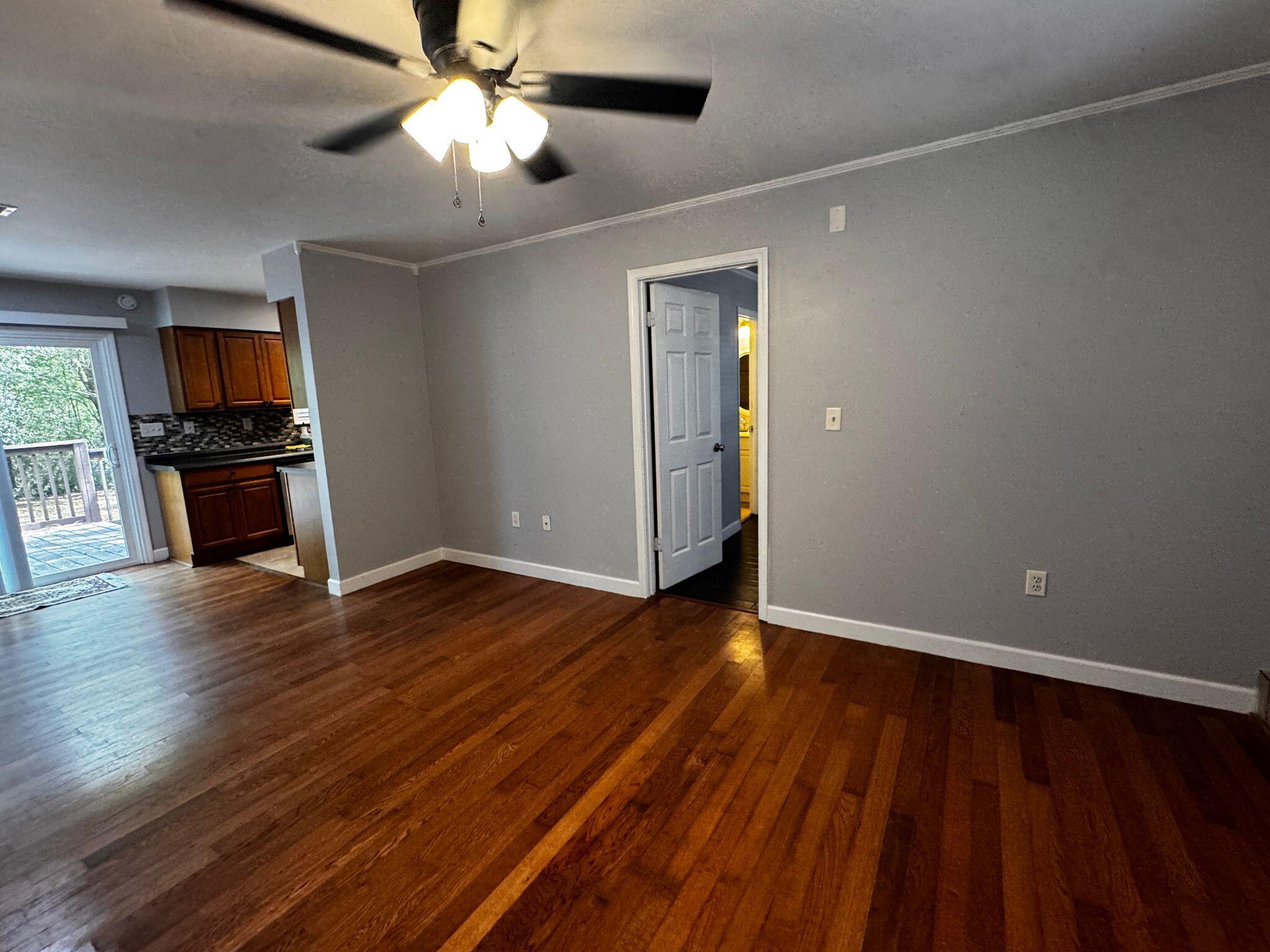 358 John King Road Crestview, FL 32539 - Photo 5 of 22 a view of empty room with wooden floor and fan