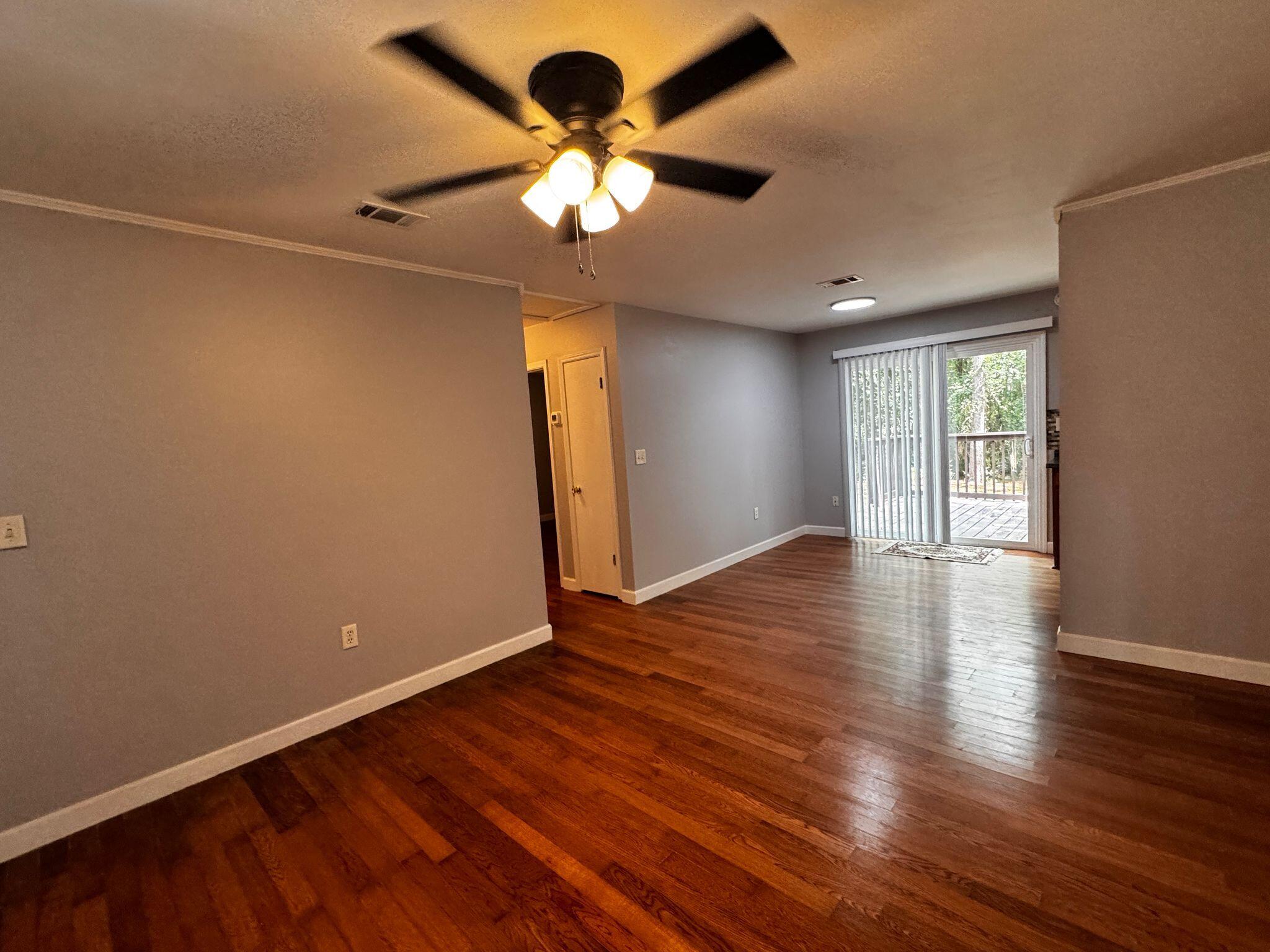 358 John King Road Crestview, FL 32539 - Photo 6 of 22 an empty room with wooden floor and windows