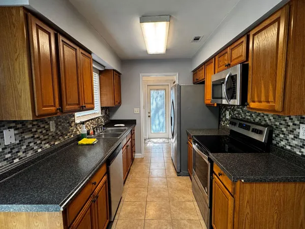 a kitchen with a sink stove and cabinets