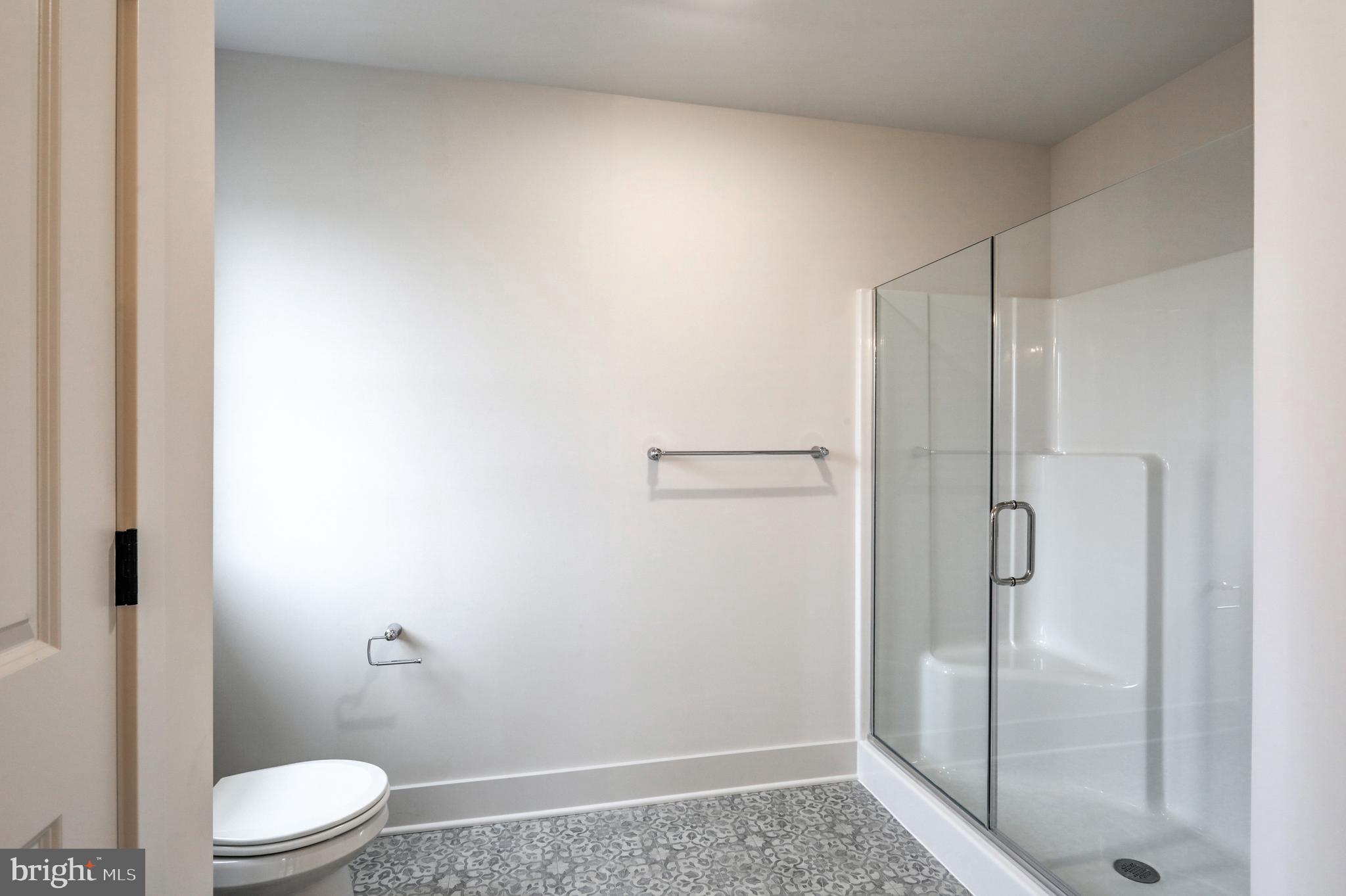 219 Coffee Goss Road Marietta, PA 17547 - Photo 10 of 12 a bathroom with a granite countertop toilet and a shower