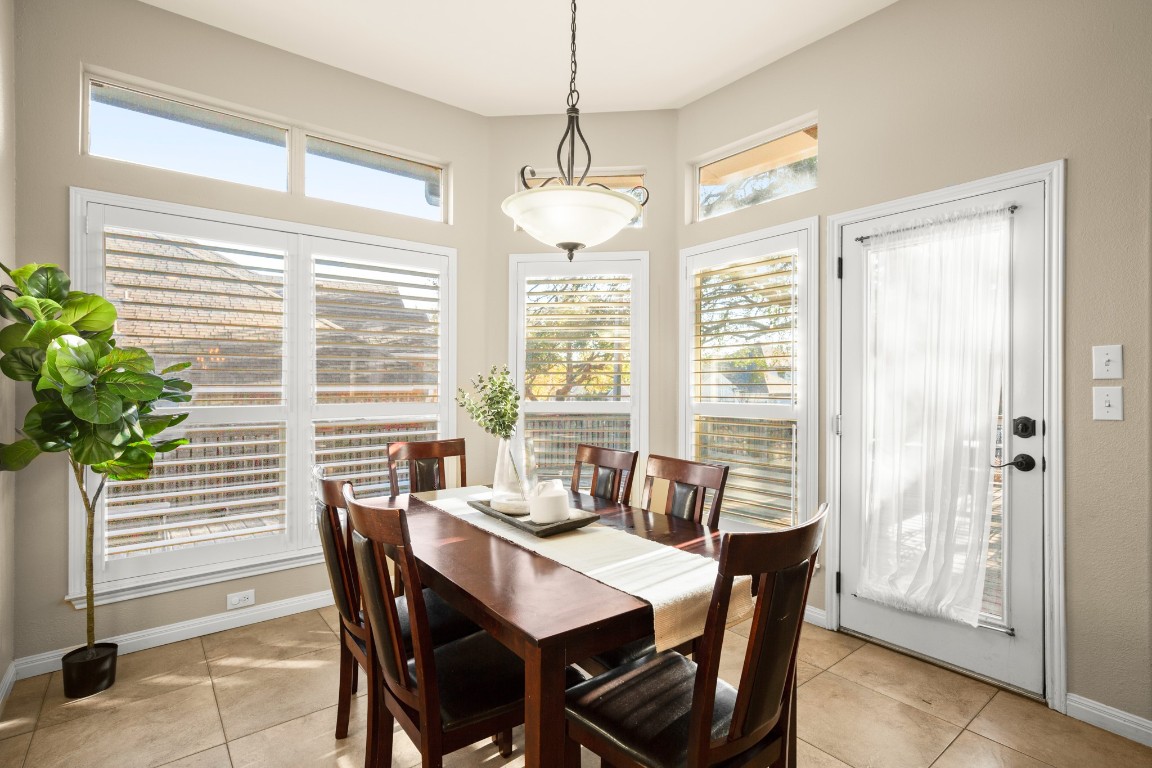 8021 Tahoe Parke Circle Austin, TX 78726 - Photo 16 of 33 a dining room with furniture and window