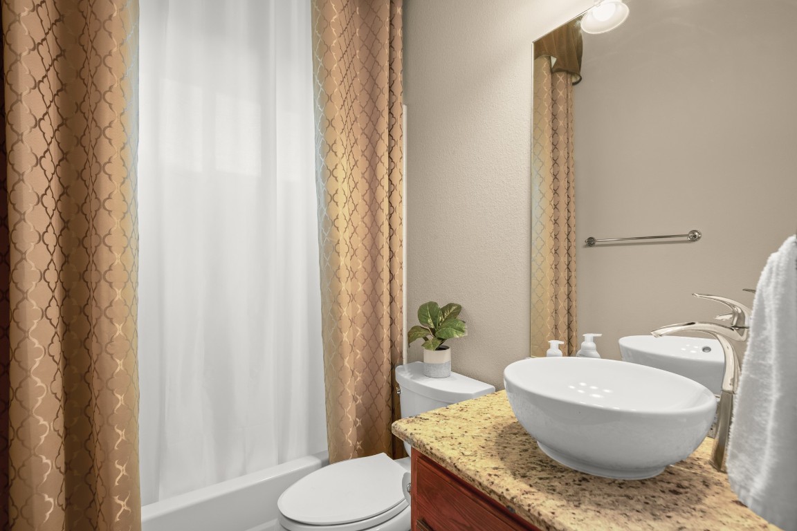 8021 Tahoe Parke Circle Austin, TX 78726 - Photo 18 of 33 a bathroom with a granite countertop sink and a mirror