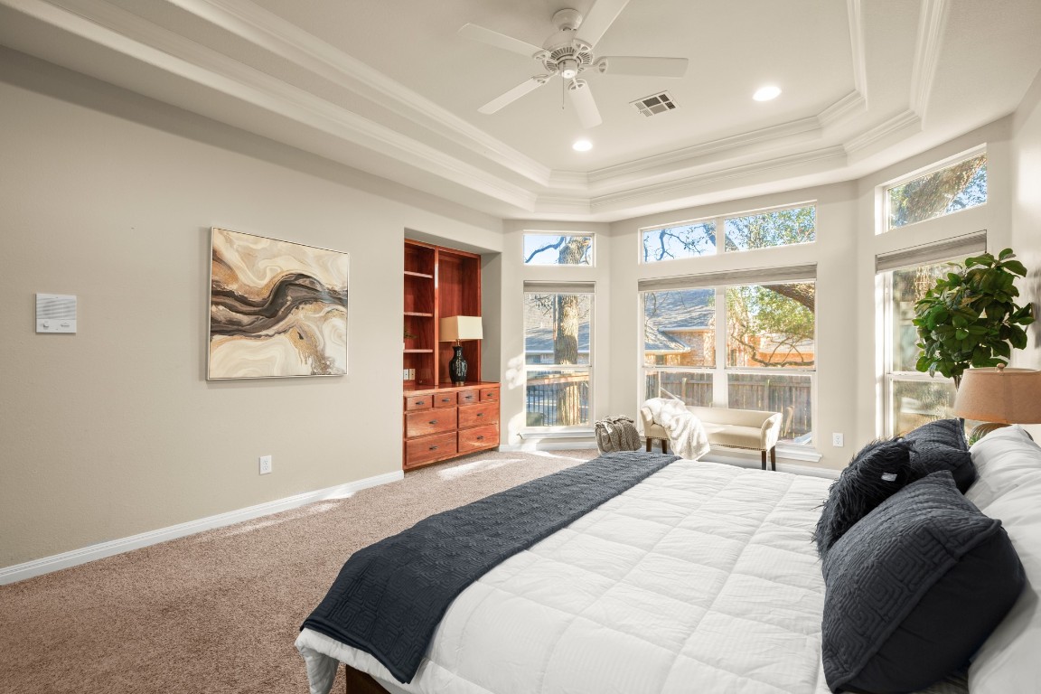 8021 Tahoe Parke Circle Austin, TX 78726 - Photo 20 of 33 a spacious bedroom with a large bed and a large window