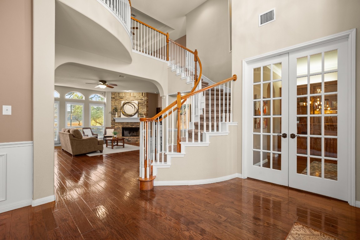 8021 Tahoe Parke Circle Austin, TX 78726 - Photo 2 of 33 a view of an entryway with wooden floor and windows