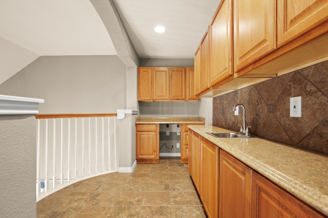 8021 Tahoe Parke Circle Austin, TX 78726 - Photo 24 of 33 a kitchen with stainless steel appliances granite countertop a sink stove and cabinets