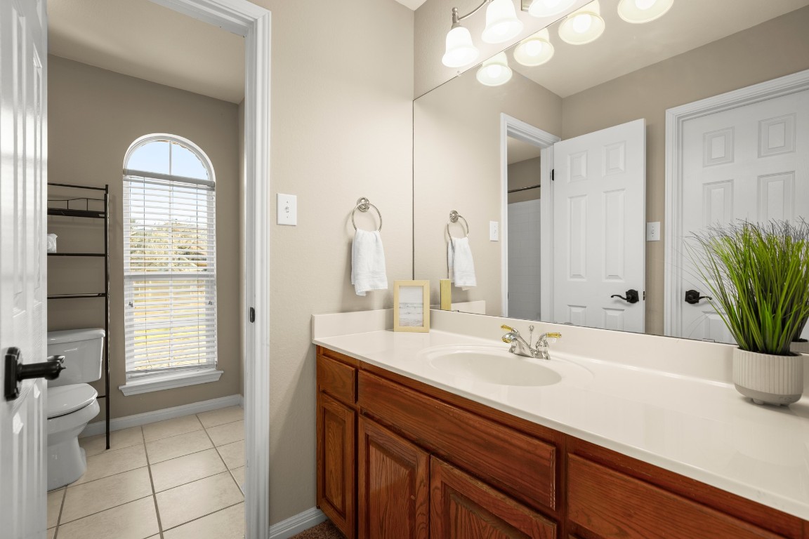 8021 Tahoe Parke Circle Austin, TX 78726 - Photo 27 of 33 a bathroom with a sink a vanity and a mirror