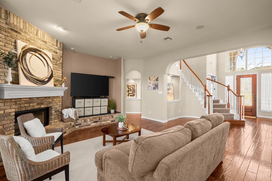 8021 Tahoe Parke Circle Austin, TX 78726 - Photo 7 of 33 a living room with furniture a flat screen tv and a fireplace