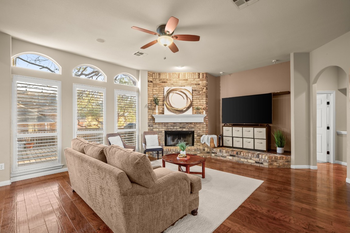 8021 Tahoe Parke Circle Austin, TX 78726 - Photo 8 of 33 a living room with furniture a large window and a flat screen tv
