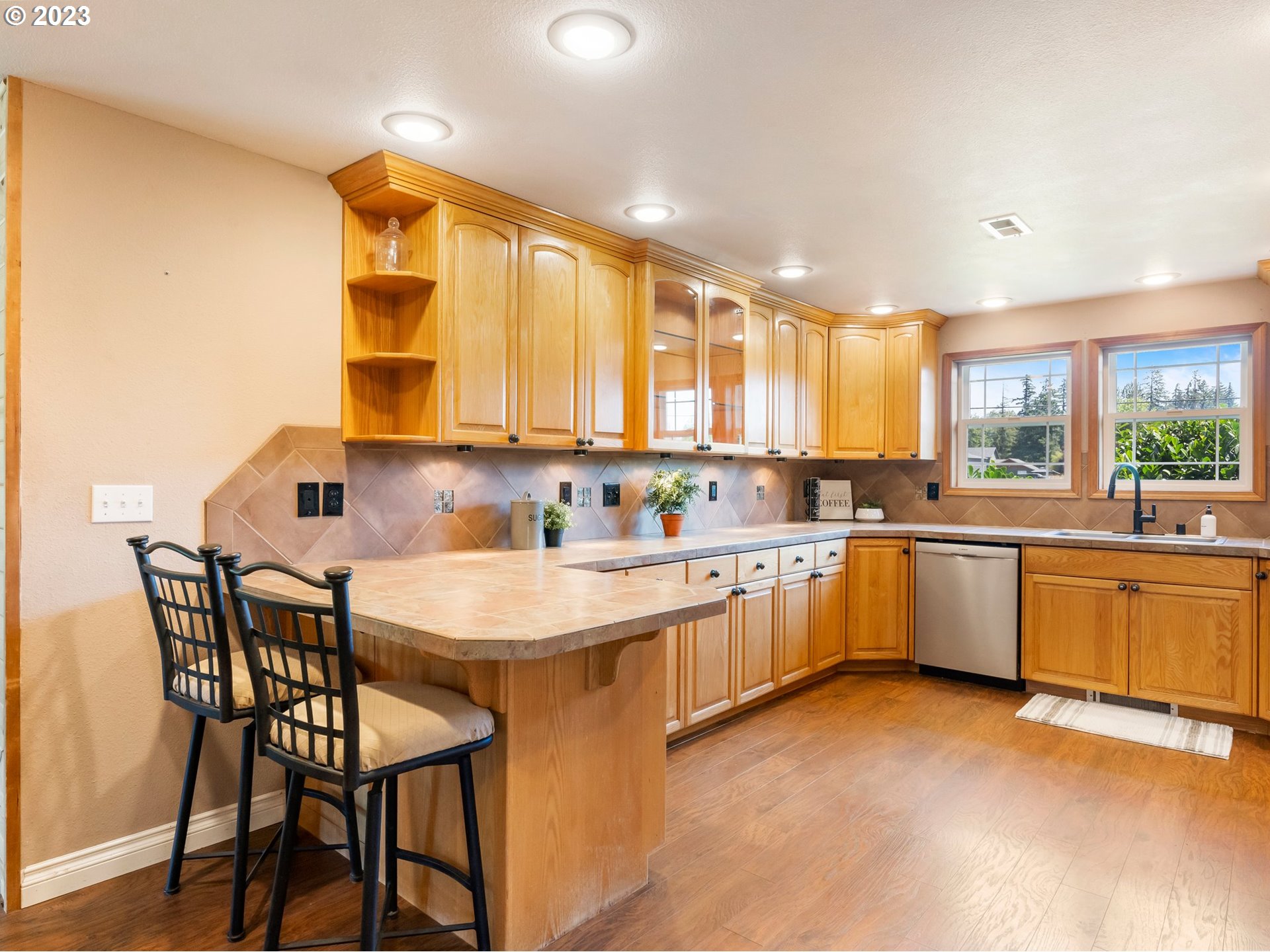 22114 Northeast 29th Avenue Ridgefield, WA 98642 - Photo 13 of 46 a large white kitchen with a sink and cabinets