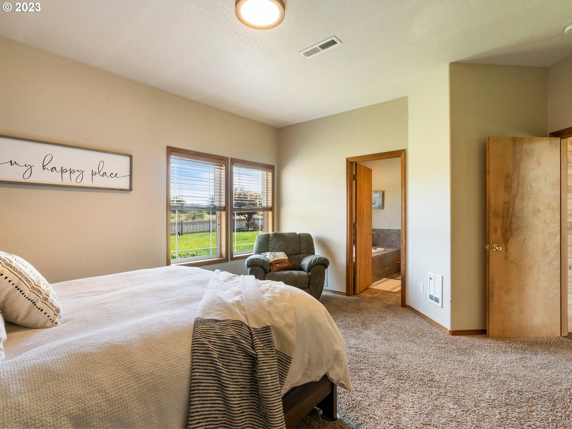 22114 Northeast 29th Avenue Ridgefield, WA 98642 - Photo 20 of 46 a bedroom with a bed and a large window