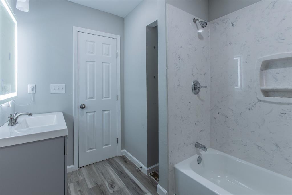 2816 Summer Avenue Waco, TX 76708 - Photo 9 of 16 a bathroom with a tub sink vanity and granite