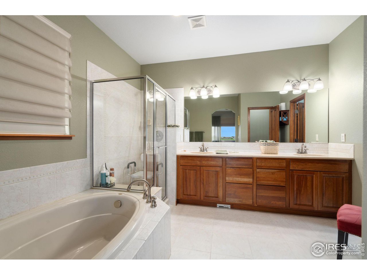 6564 Half Moon Bay Drive Windsor, CO 80550 - Photo 18 of 28 a spacious bathroom with a tub sink and mirror