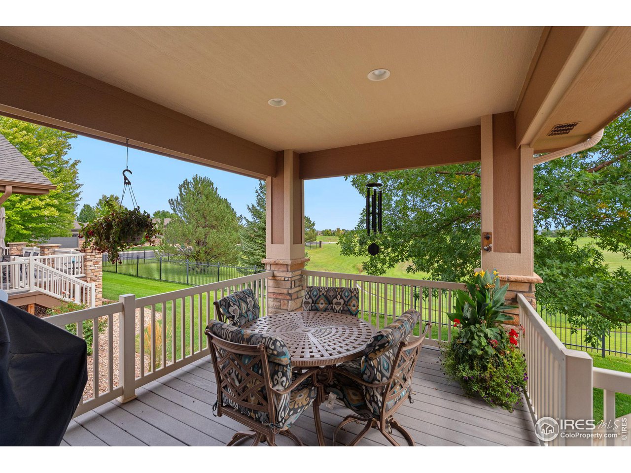 6564 Half Moon Bay Drive Windsor, CO 80550 - Photo 22 of 28 a view of a chairs and table in patio with a yard
