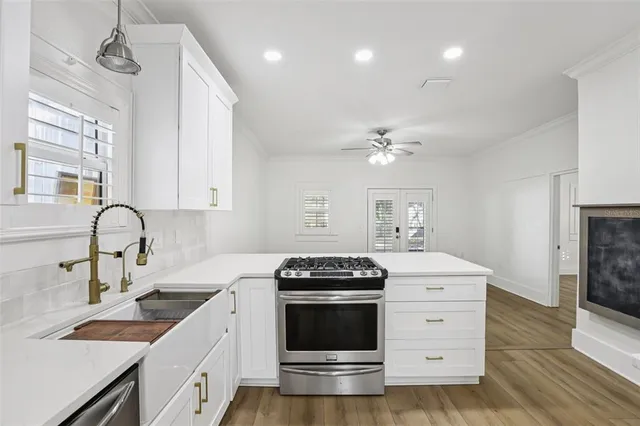 a kitchen with a stove and white cabinets