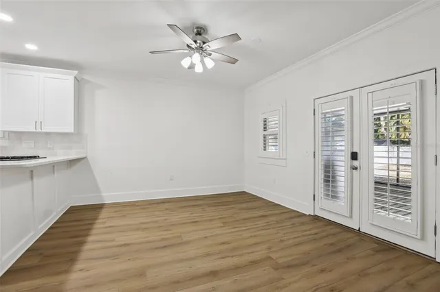a view of an empty room with wooden floor