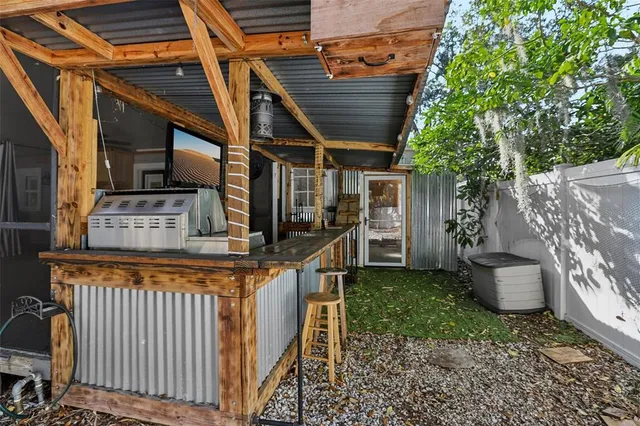 a view of a backyard with seating space