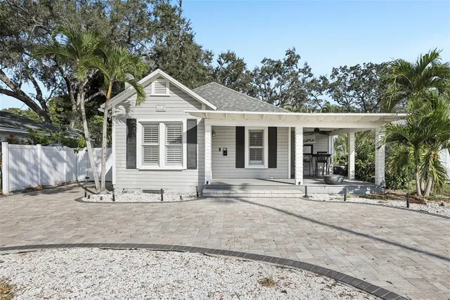 a front view of a house with a yard and seating space