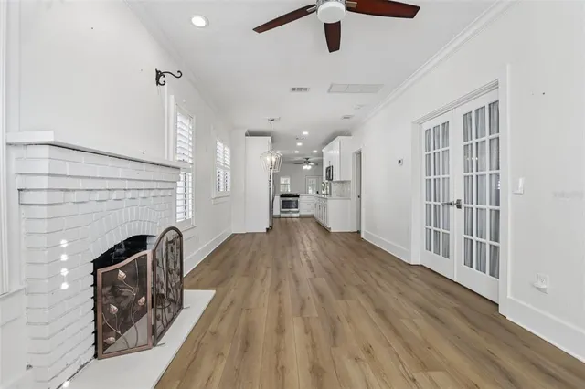 wooden floor in an empty room with a fireplace