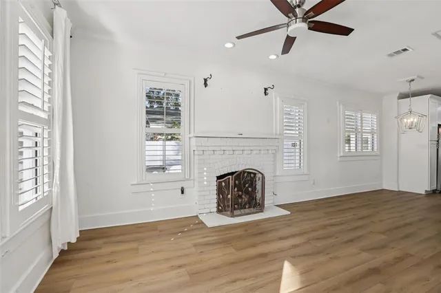 a view of a livingroom with a fireplace and window