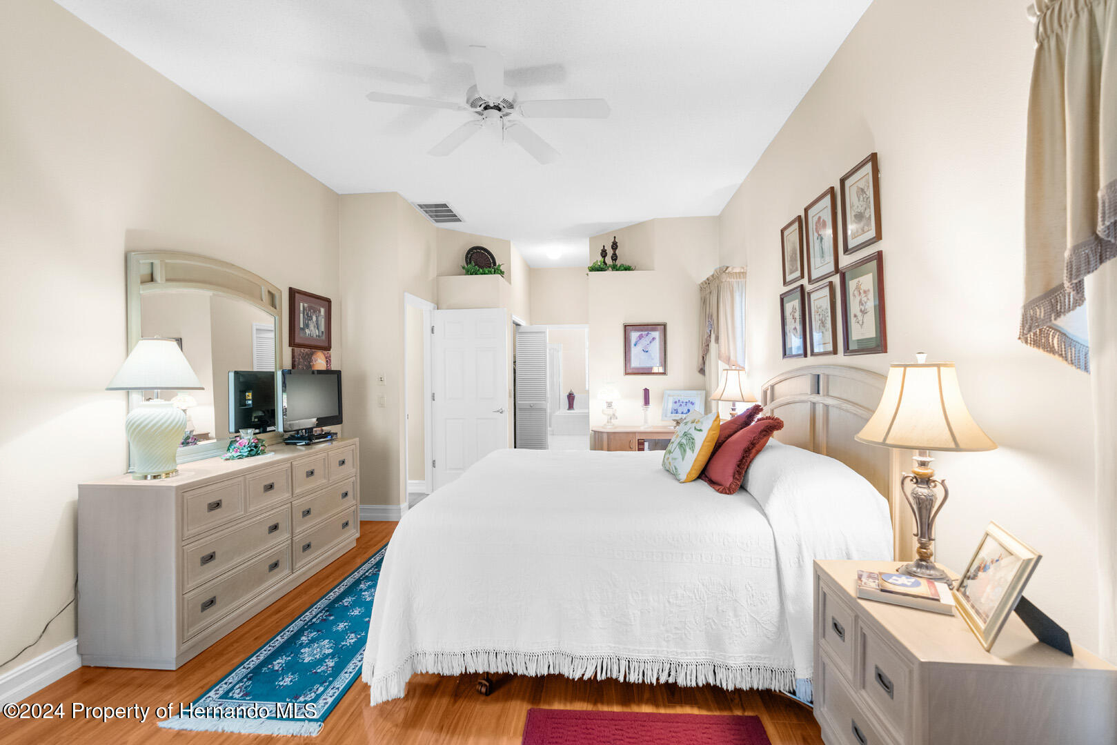 7424 Harvard Hills Place Spring Hill, FL 34606 - Photo 12 of 38 a bedroom with a bed and a dresser in it