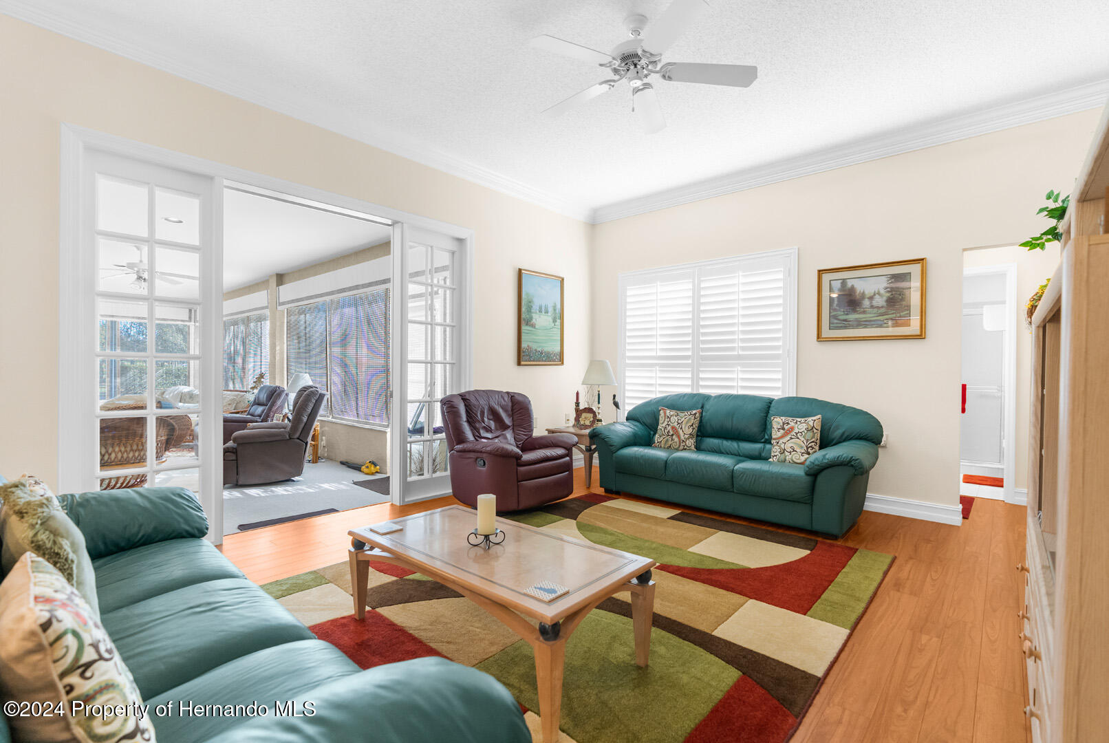 7424 Harvard Hills Place Spring Hill, FL 34606 - Photo 18 of 38 a living room with furniture and a window