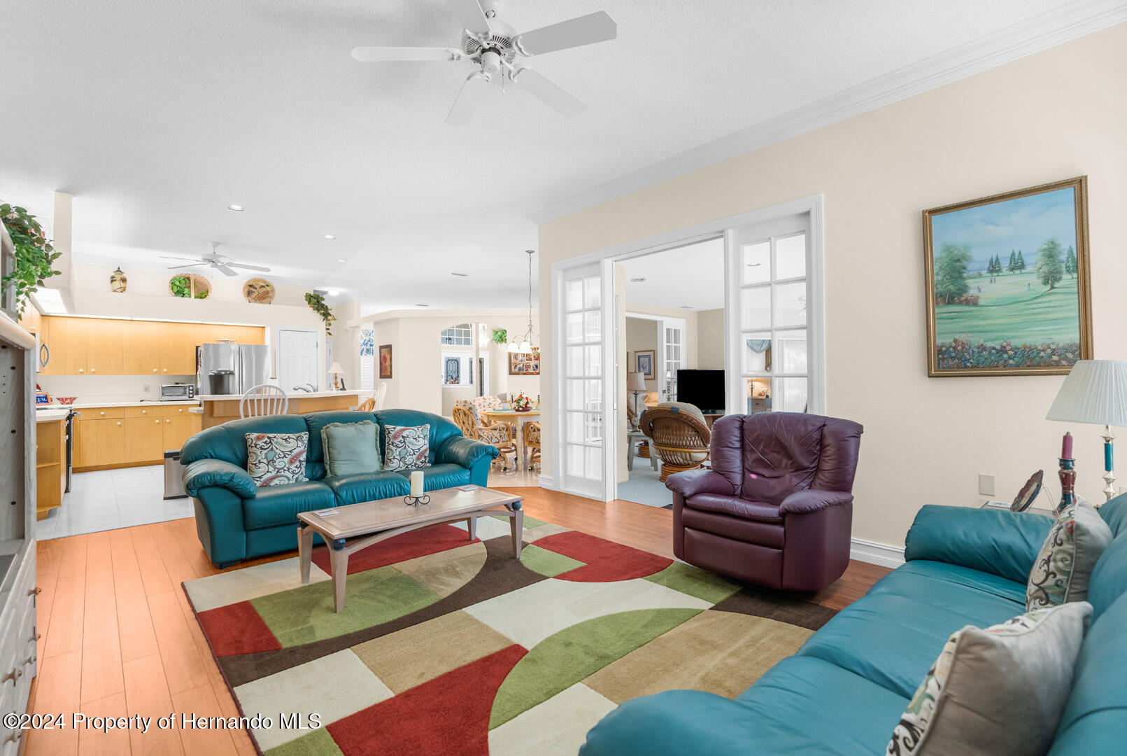 7424 Harvard Hills Place Spring Hill, FL 34606 - Photo 19 of 38 a living room with furniture and a view of kitchen