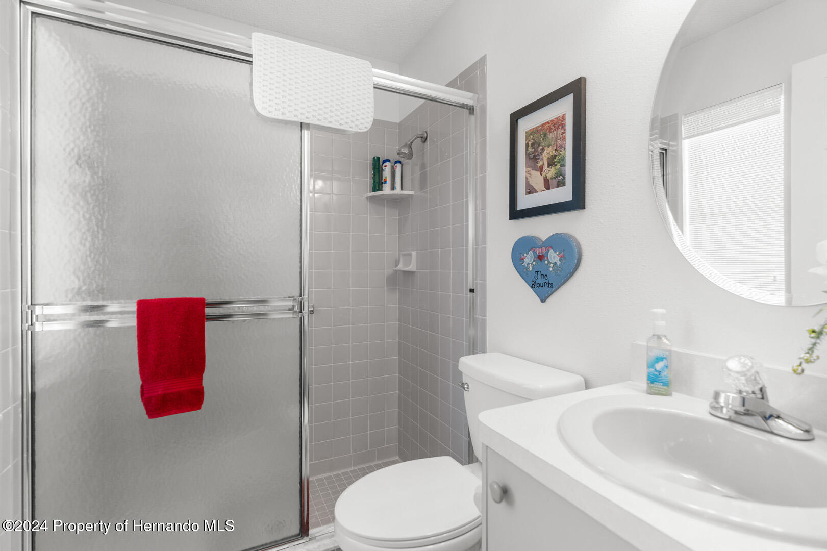 7424 Harvard Hills Place Spring Hill, FL 34606 - Photo 25 of 38 a bathroom with a sink toilet and shower