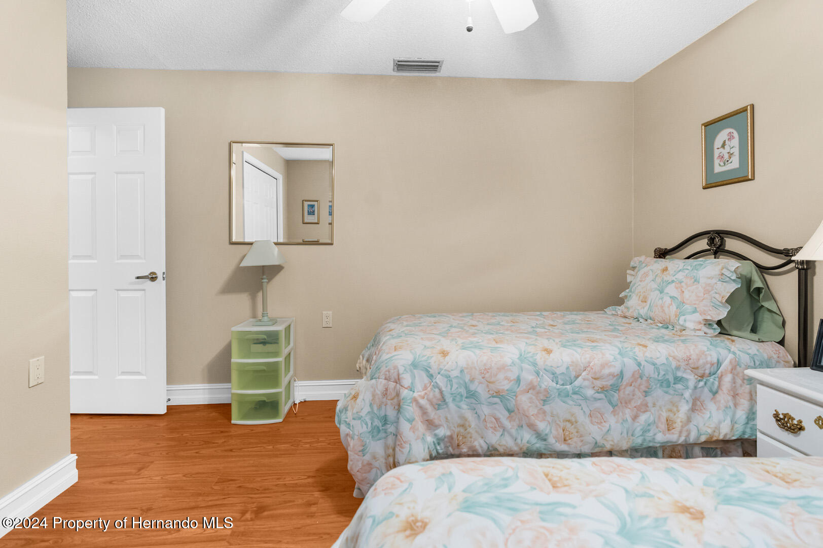 7424 Harvard Hills Place Spring Hill, FL 34606 - Photo 29 of 38 a bedroom with a bed and wooden floor