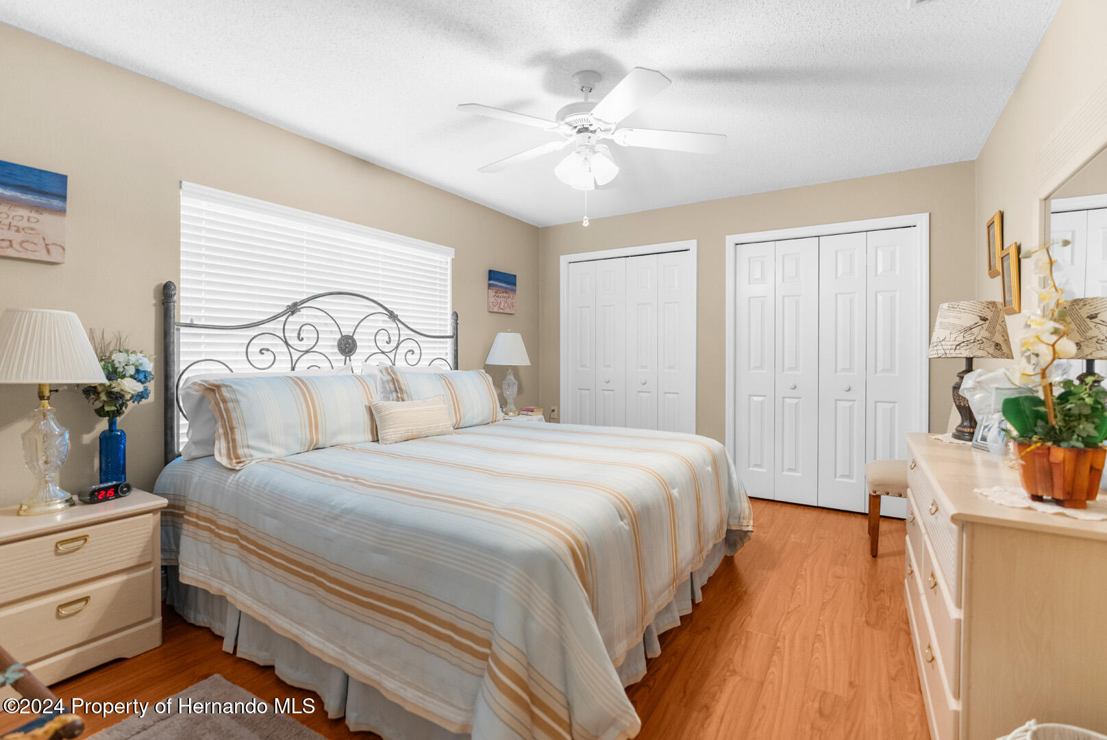 7424 Harvard Hills Place Spring Hill, FL 34606 - Photo 31 of 38 a bedroom with bed and a chandelier