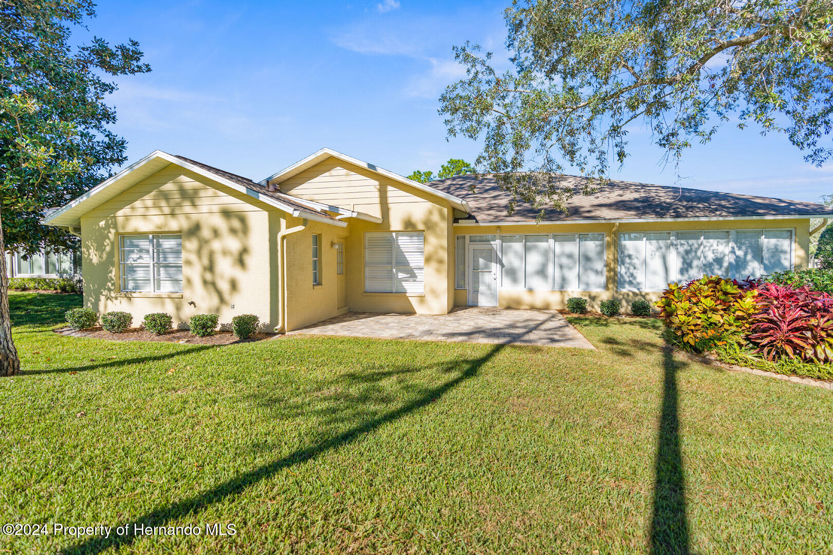 7424 Harvard Hills Place Spring Hill, FL 34606 - Photo 33 of 38 a front view of a house with garden