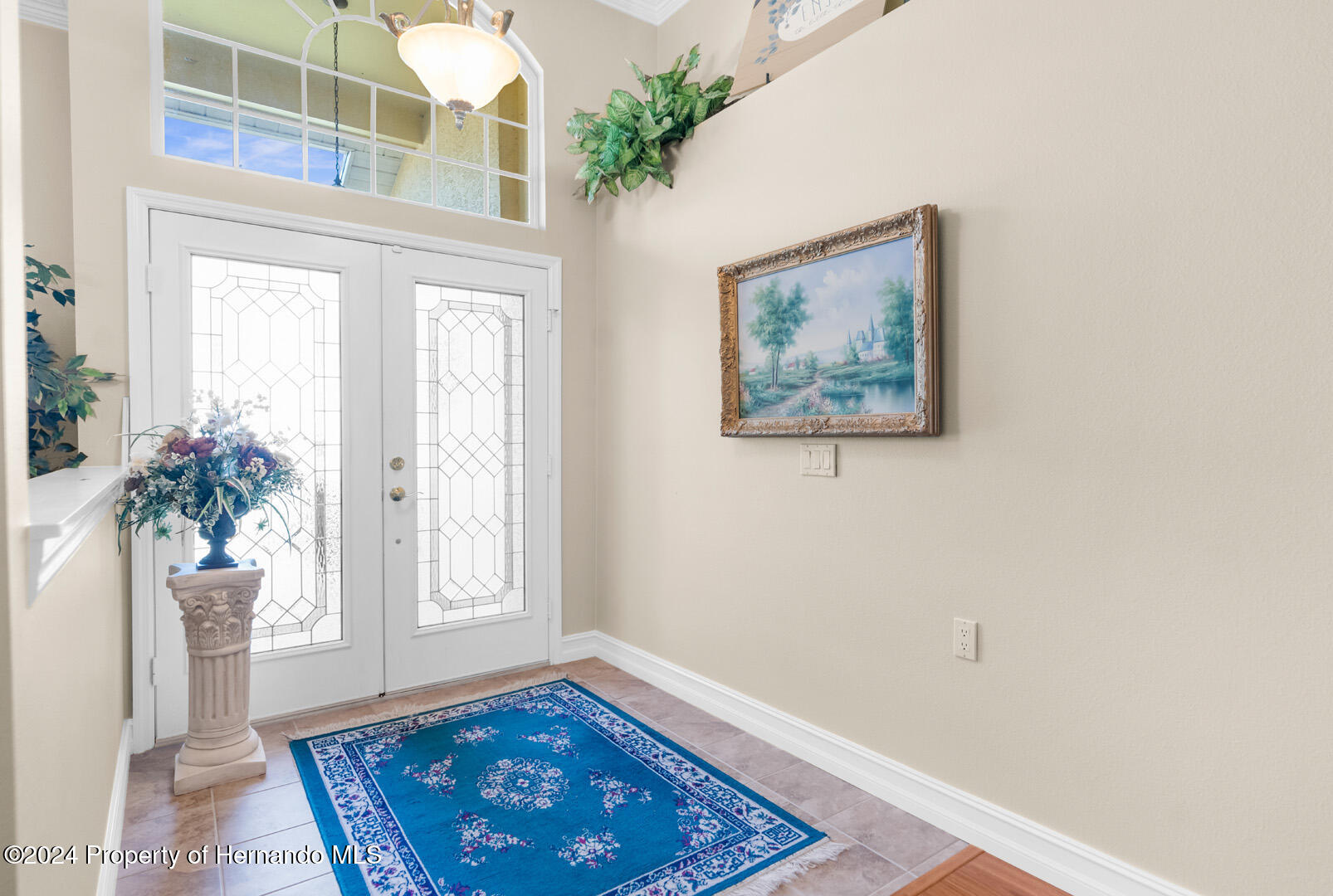 7424 Harvard Hills Place Spring Hill, FL 34606 - Photo 7 of 38 a view of an entryway with wooden floor