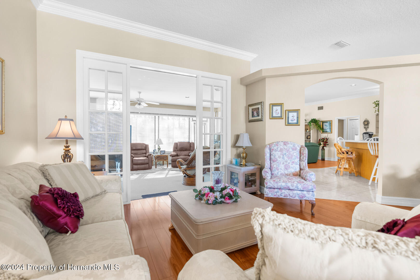 7424 Harvard Hills Place Spring Hill, FL 34606 - Photo 8 of 38 a living room with furniture and a large window