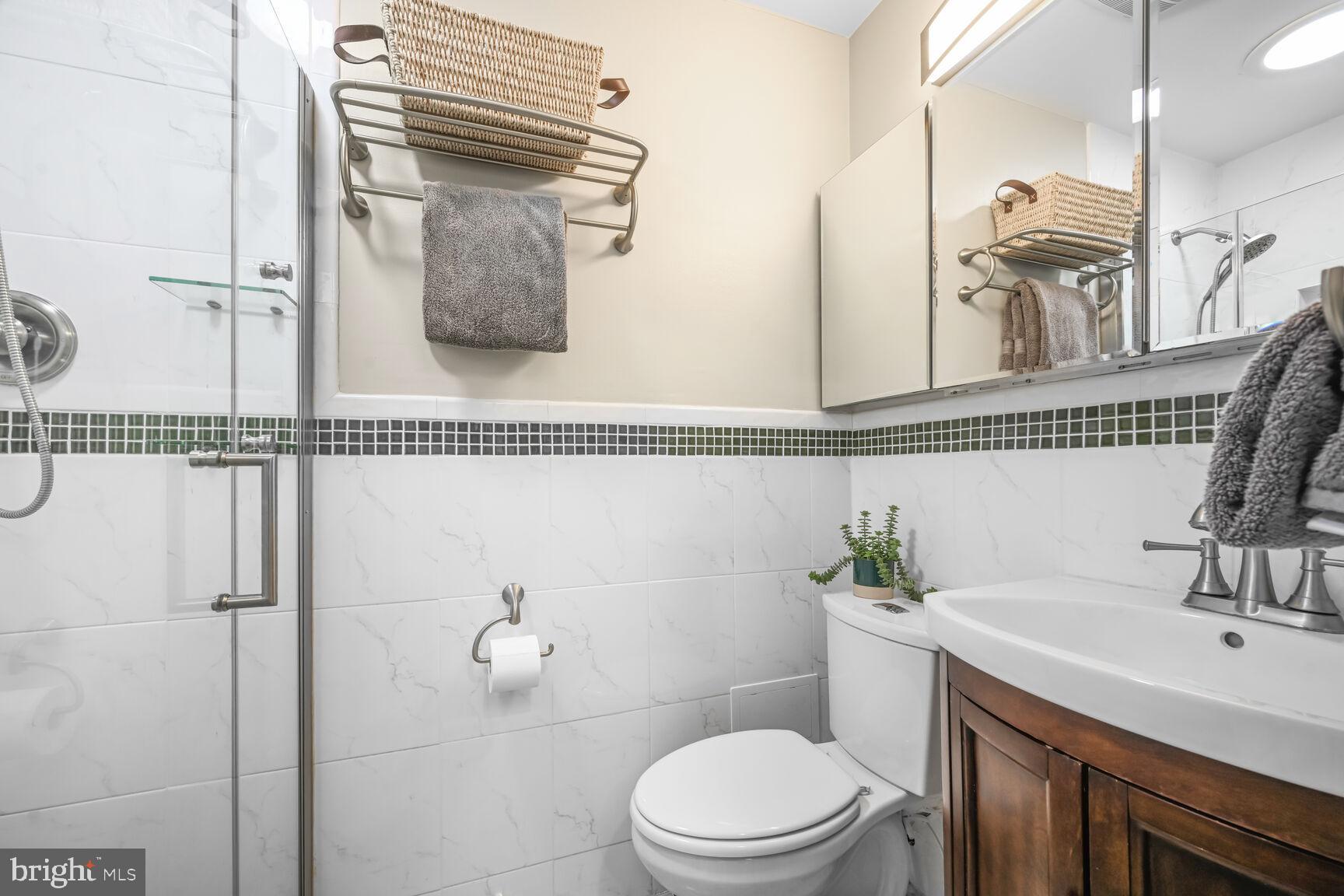 2308 Peggy Lane Silver Spring, MD 20910 - Photo 14 of 27 a bathroom with a sink a toilet and mirror